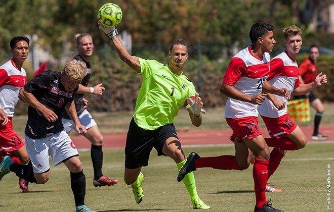 Russ Klabough (senior, criminal justice) lobs a pass down the pitch against NDNU