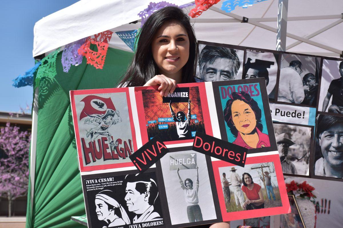 Stan State student Vanessa Uribe (senior, Criminal Justice) stands in quad to inform students of Chavez's life and importance