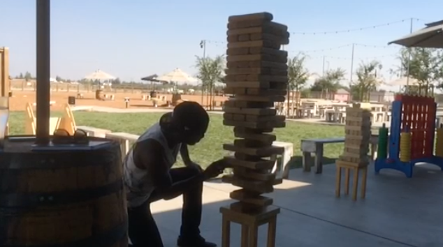 &#160;Andrew County (Signal Writer) in the Dust Bowl courtyard playing Jenga.