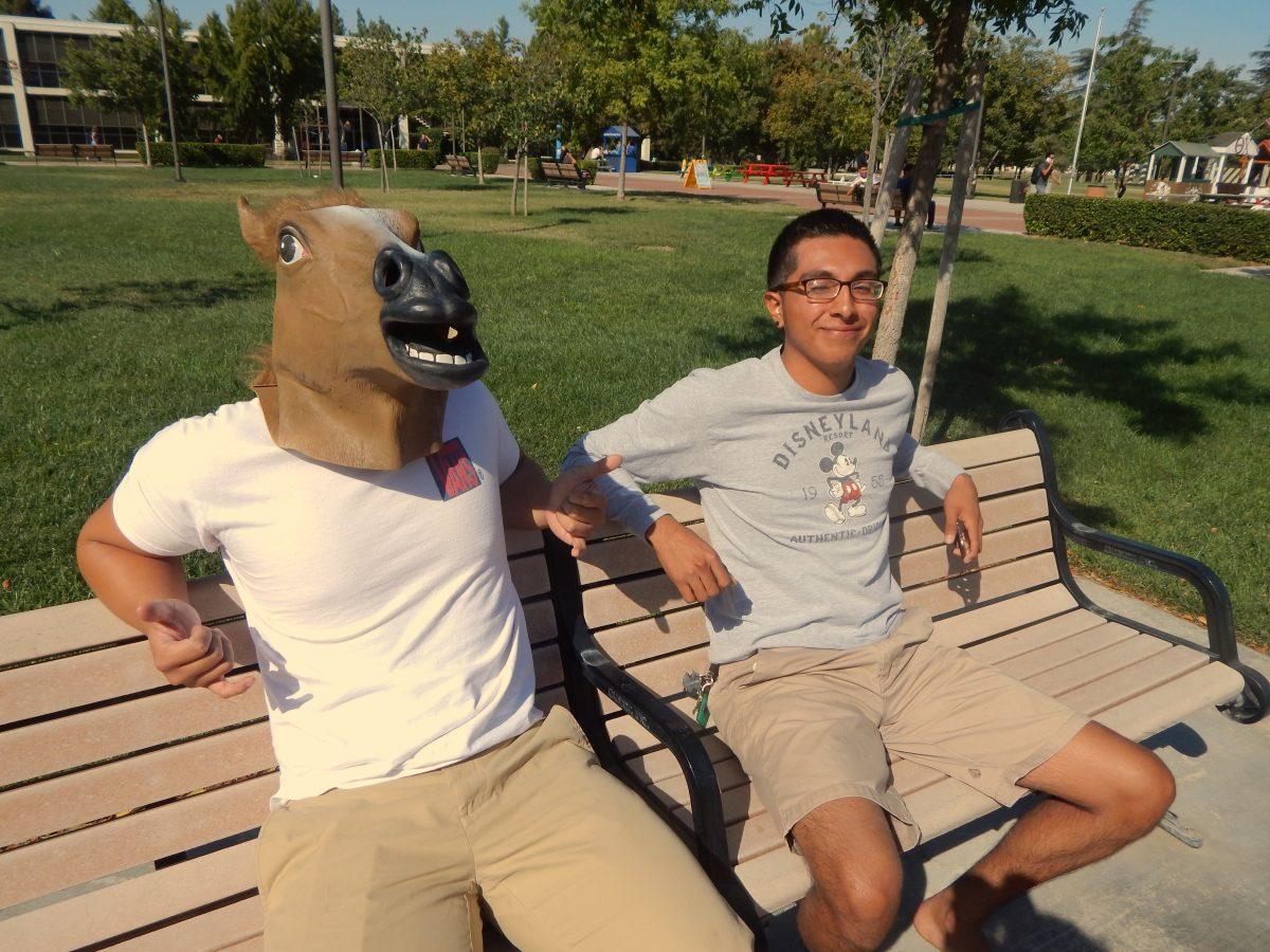 H. Capistrano and Matthew Rodriguez sitting and relaxing as students pass by.