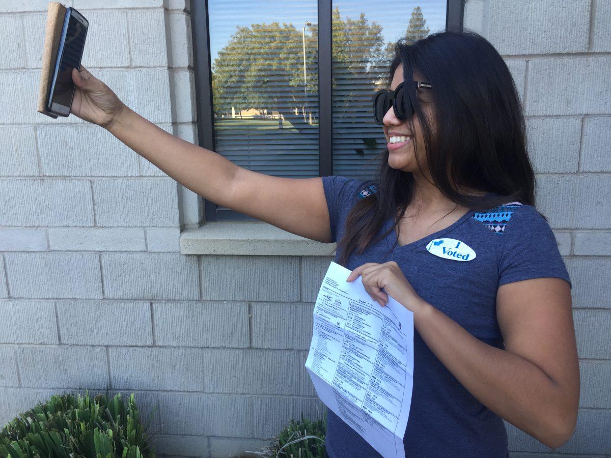 Stan State student and Signal reporter Hilda Flores practices for future ballot selfies.