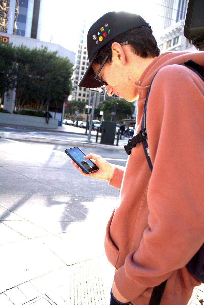 Mario Mu&#241;iz (senior, Computer Science) plays Pok&#233;mon&#160;GO on the first day of its release in San Francisco. (The Signal/Tatiana Olivera)