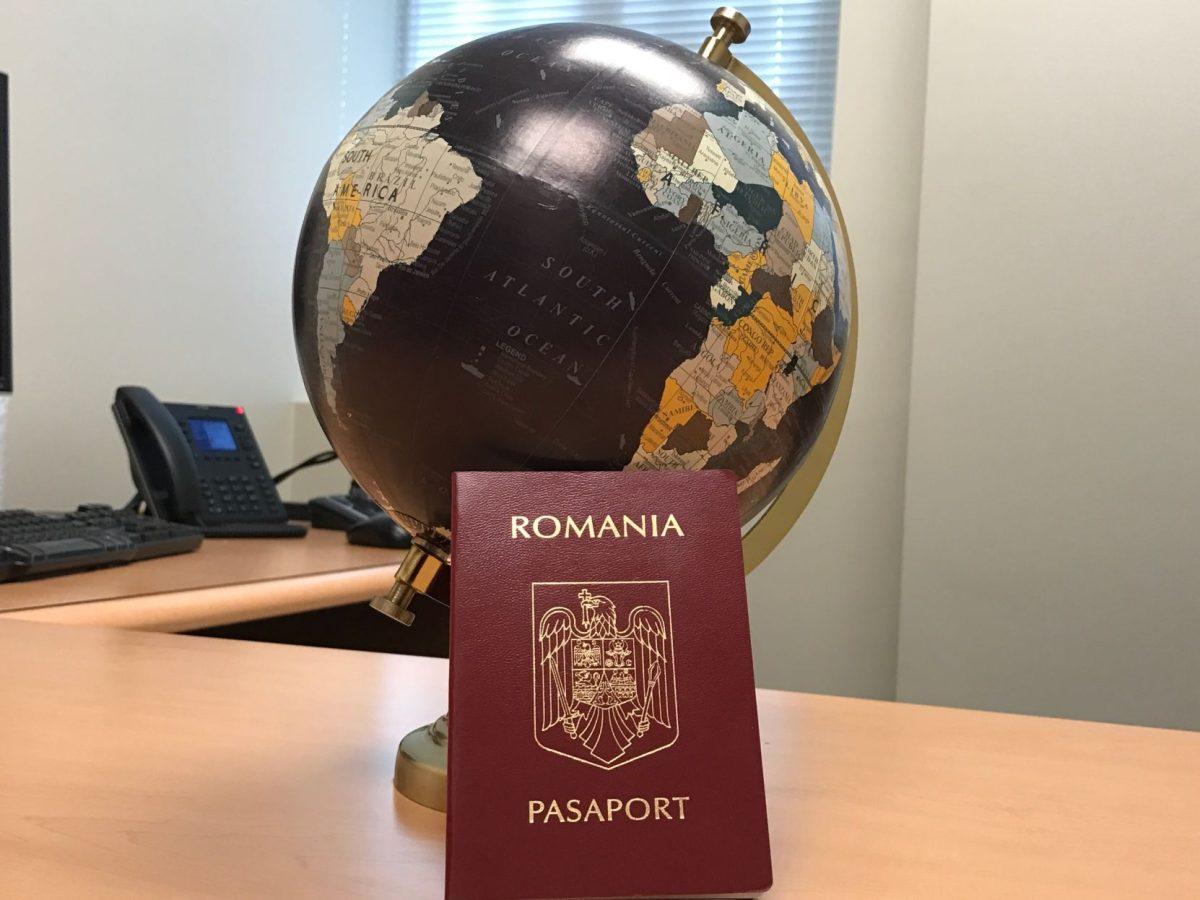 Passport of Romania provided by Dr. Daniel Horvath next to a globe, representing one of the five countries that the United States requires its citizens to have a visa before entering the United States. (The Signal/Vanessa Olmos)