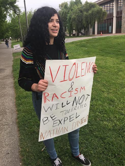 Jazmin Buenrostro, a Turlock native and student at CSUMB, stands outside of the library encouraging Damigo's expulsion on Apr. 17, 2017. (Photo Courtesy of Jason Campbell)