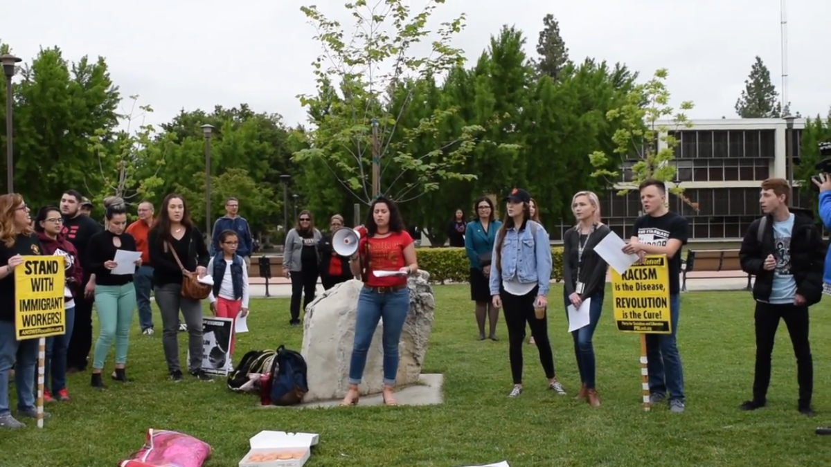 This still from the Community Unity Rally video shows students, faculty and community members shouting chants in support of the rally.