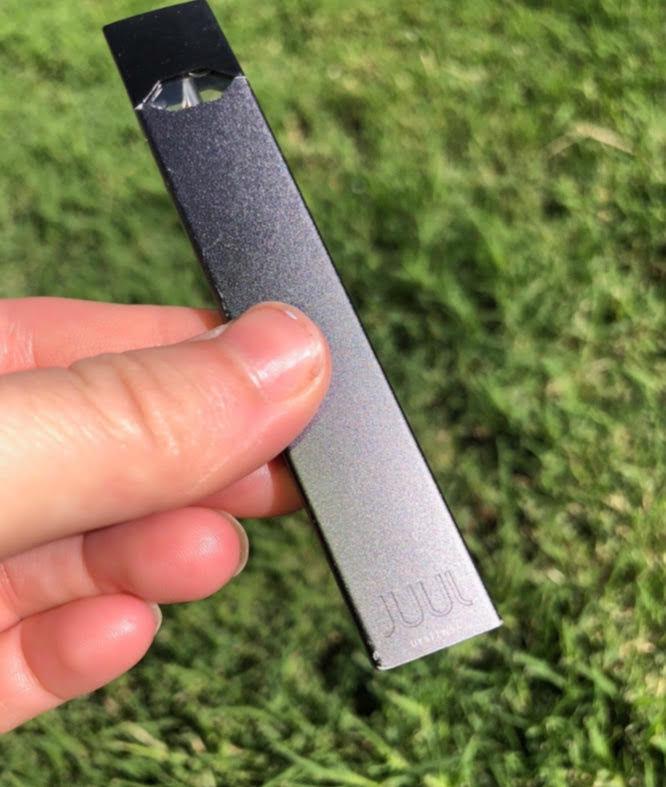 Maddie Nicholas holds her Juul to the light&#160;