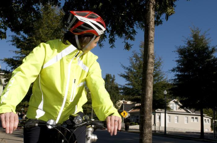 This biker is taking extra safety precautions with her reflective jacket and helmet. (Photo courtesy of CDC/ Amanda Mill)