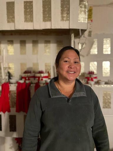 <p>May Yang stands proudly in front of her altar. (Photo courtesy of Alina Yang)</p>