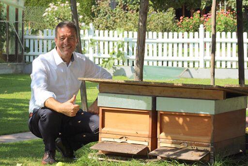 Beekeeper Peter Baur in front of some of his hives in a small town in Bavaria, Germany. (Photo by Julia Lorenz)