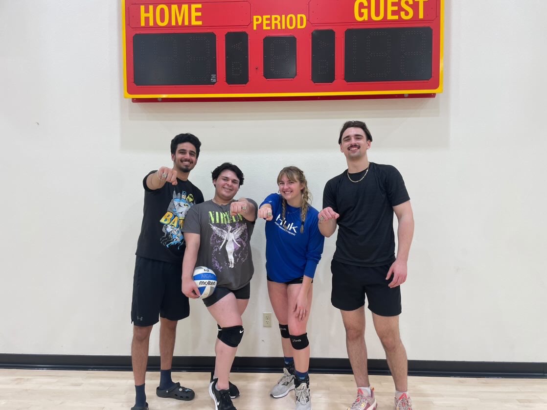 Jose Cano (grey shirt) and his 3 teammates with their 4 v 4 volleyball championship ring.