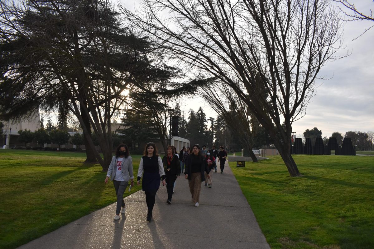 Students and Stanislaus faculty engaging with one another while returning back to the walks start. 