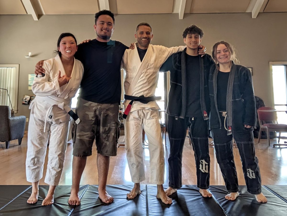 Jiu Jitsu students and instructor (Jeremiah Washington) take a group picture after class. 
