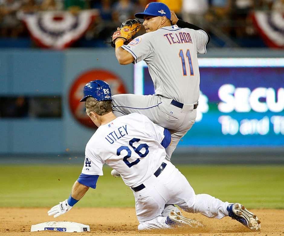 Utley slides to second base, colliding with Tejada and disrupting double play