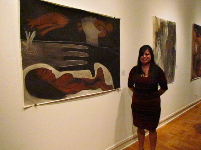 Guadalupe Mosqueda next to her art piece "Surprised Thoughts"