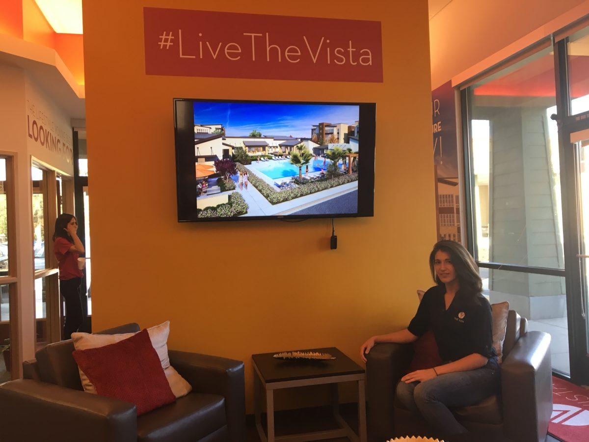 Courtney Jurasko, displaying some of the furnishings that will featured in the new apartments, including a flat-screen television