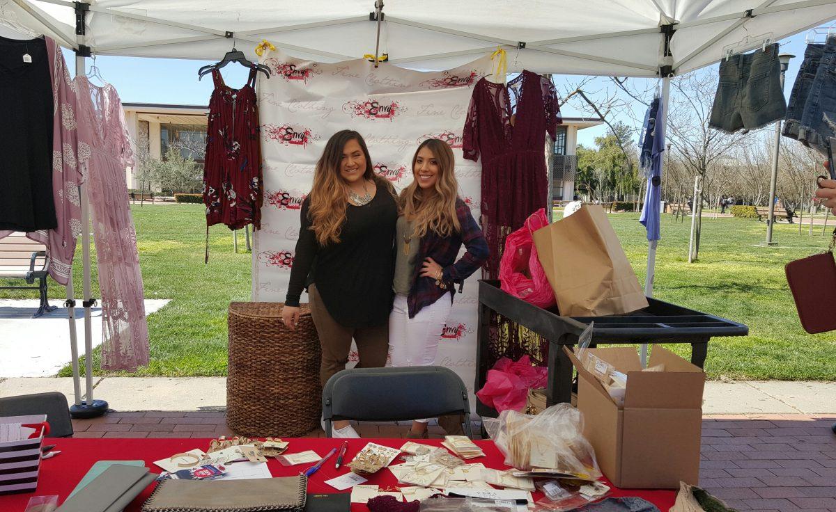 Envy Fine Clothing representatives during the discount fair at Stan State's quad. (Signal Photo/Jyoti Dhanota)