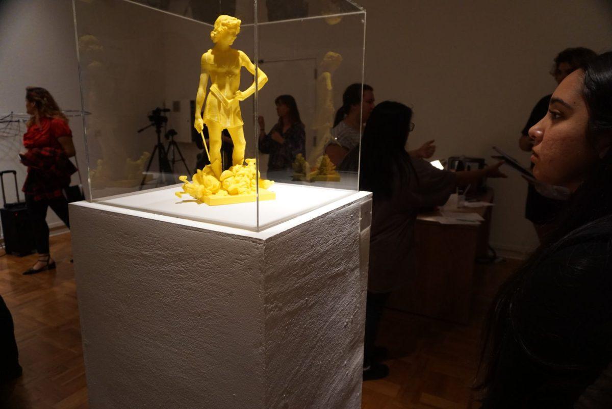 Alondra Quevedo admires Daniel Edwards' Verrocchio's David with Beheadings.&#160;(Signal Photo/Aubrie Barr)