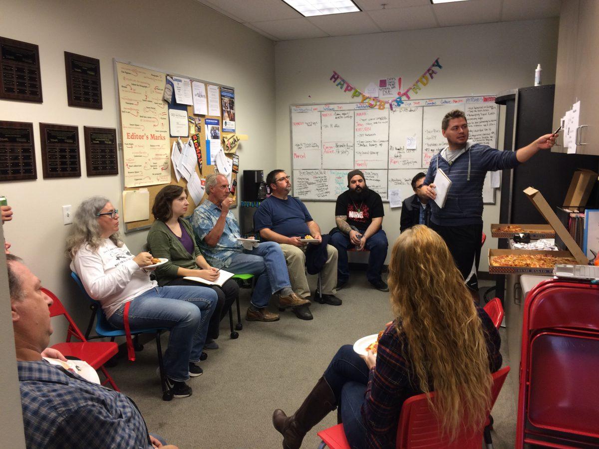 Graphic designers, print shop members, and The Signal advisor discussing the redesign. (Signal Photo/ Clara Zapien)