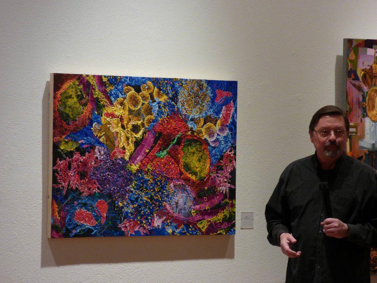 Artist John McNamara explaining one of his paintings. (Signal Photo/Andrew Cabrera)&#160;