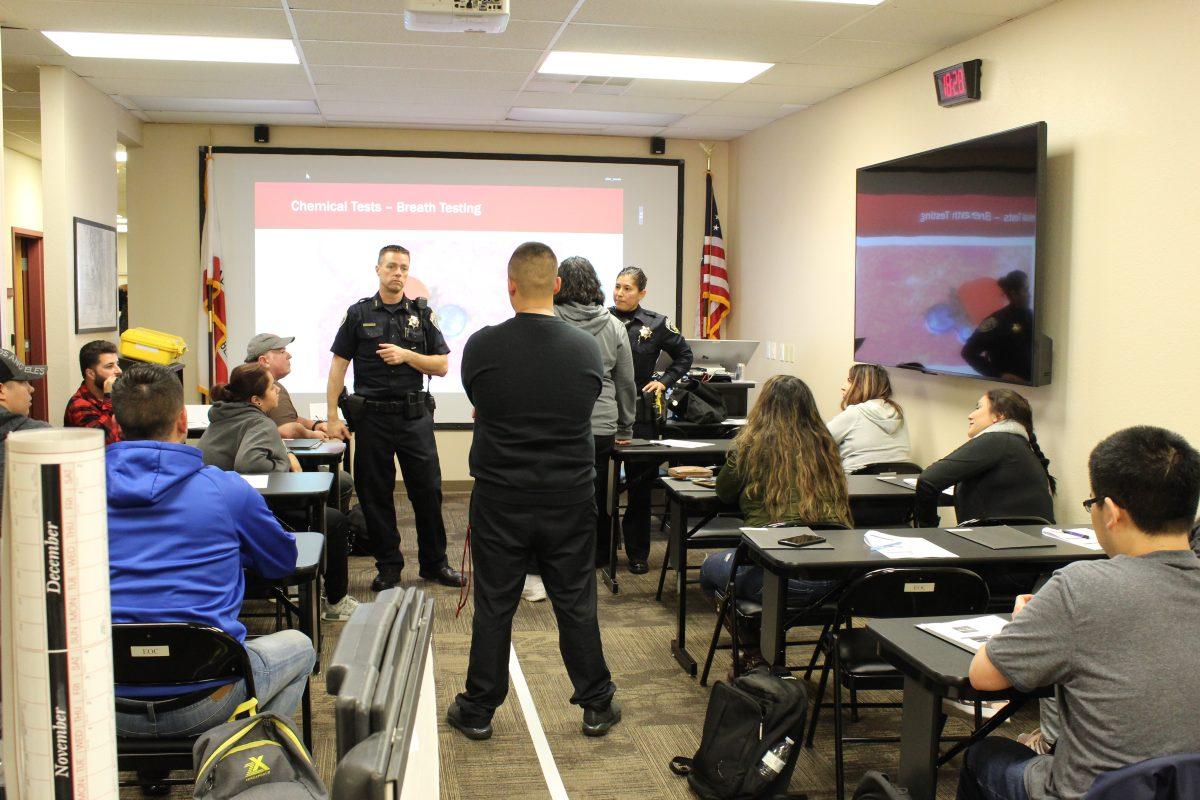 Chief Clint Strode and fellow other officers carrying out mock DUI tests with volunteers. (Signal Photo/Adino Byrd)