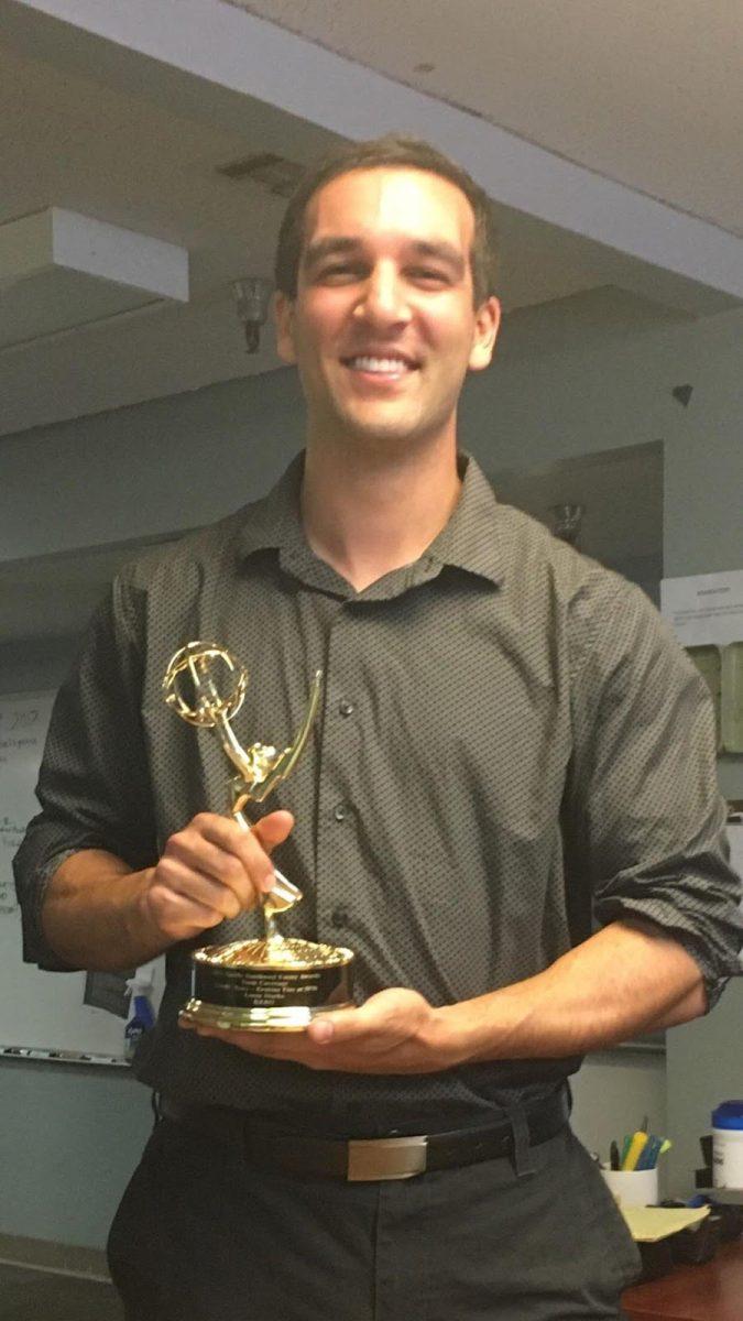 Photo of Kenneth Mashinchi holding the Emmy he won during his time working in Bakersfield, California.