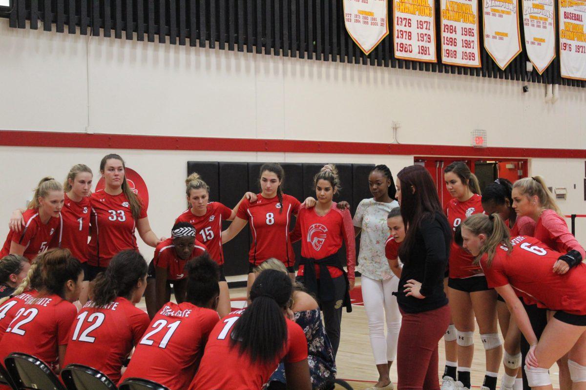 Warriors gather in to get direction from Head Coach Mallori Gibson-Rossi.