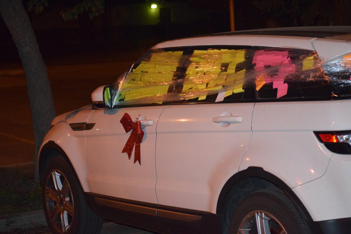 Coach Mallori's Car, covered in post-it notes, wrapped in saran wrap, and finished off with a bow.