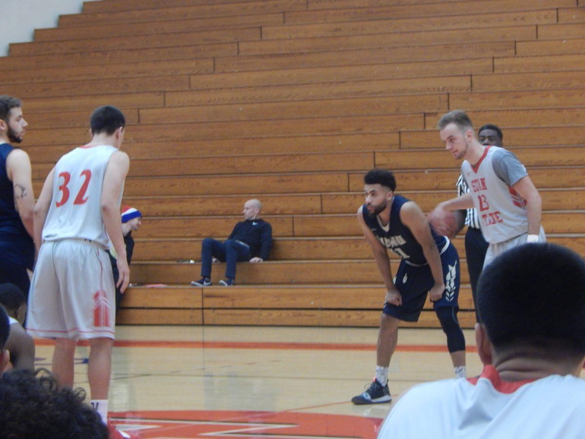 Jacob Danhoff and Vasilije Saraba get ready for opening tip off. (Signal photo/Austin Bathke)