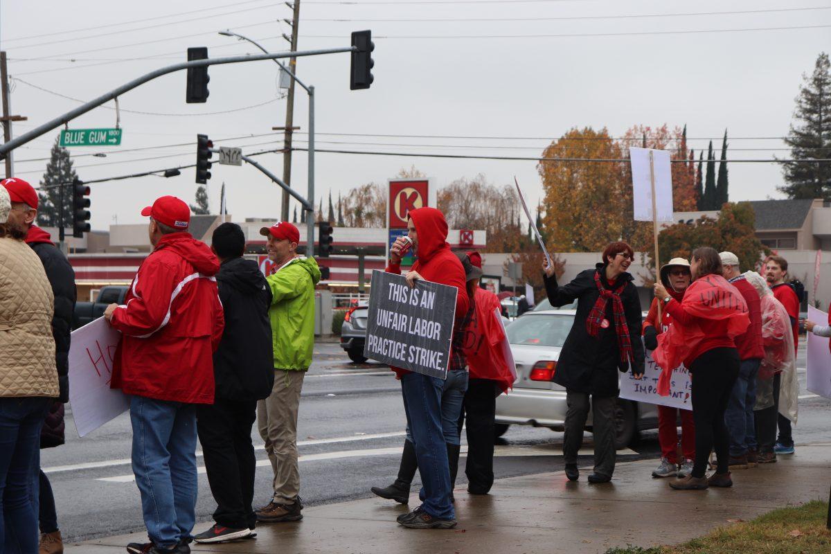 MJC Faculty standing and protesting, despite windy and rainy conditions. (Kayla Santana/Signal Photo)