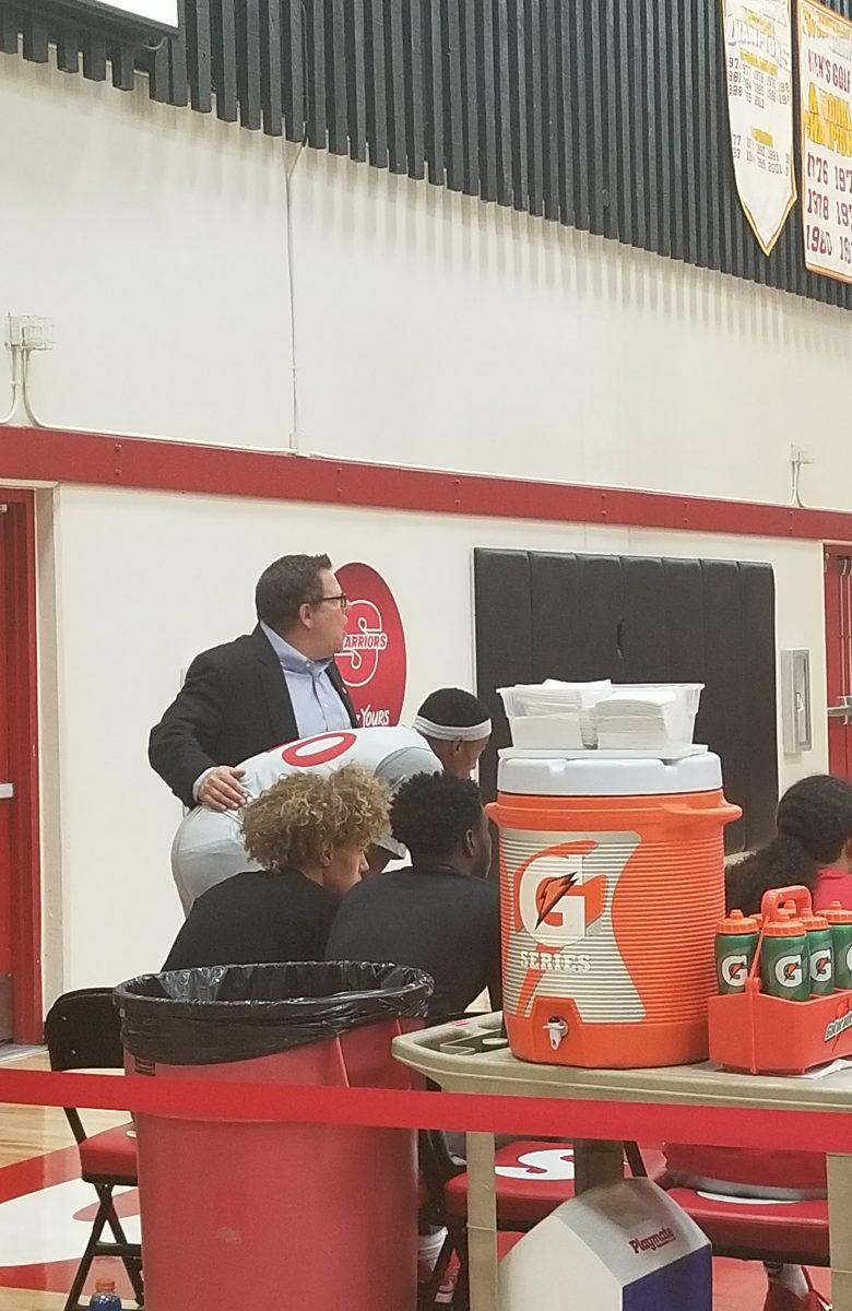 After replacing him on the court, Coach Trevor gives Fred Lavender (junior, Sociology) a pep talk. (Signal photo/Austin Bathke)