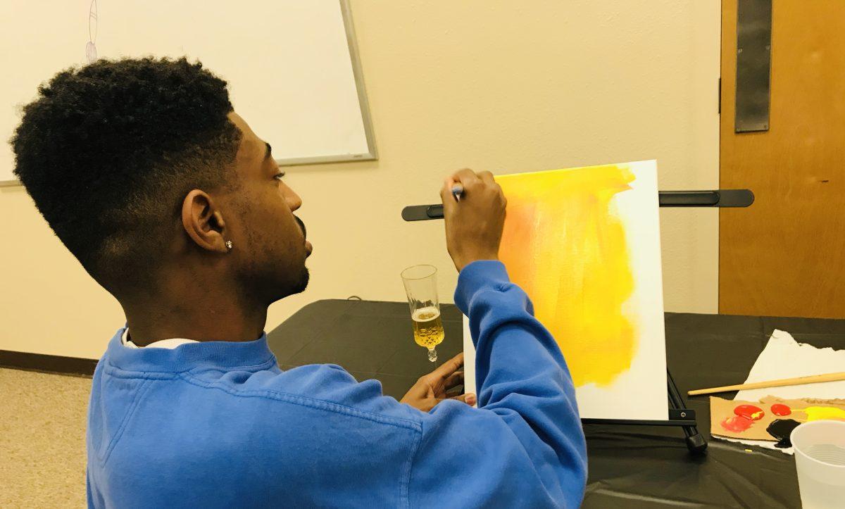 Ashton Holmes (senior, Art) represented BSU by leading their paint night.(Signal photo/Abrianna Munoz)