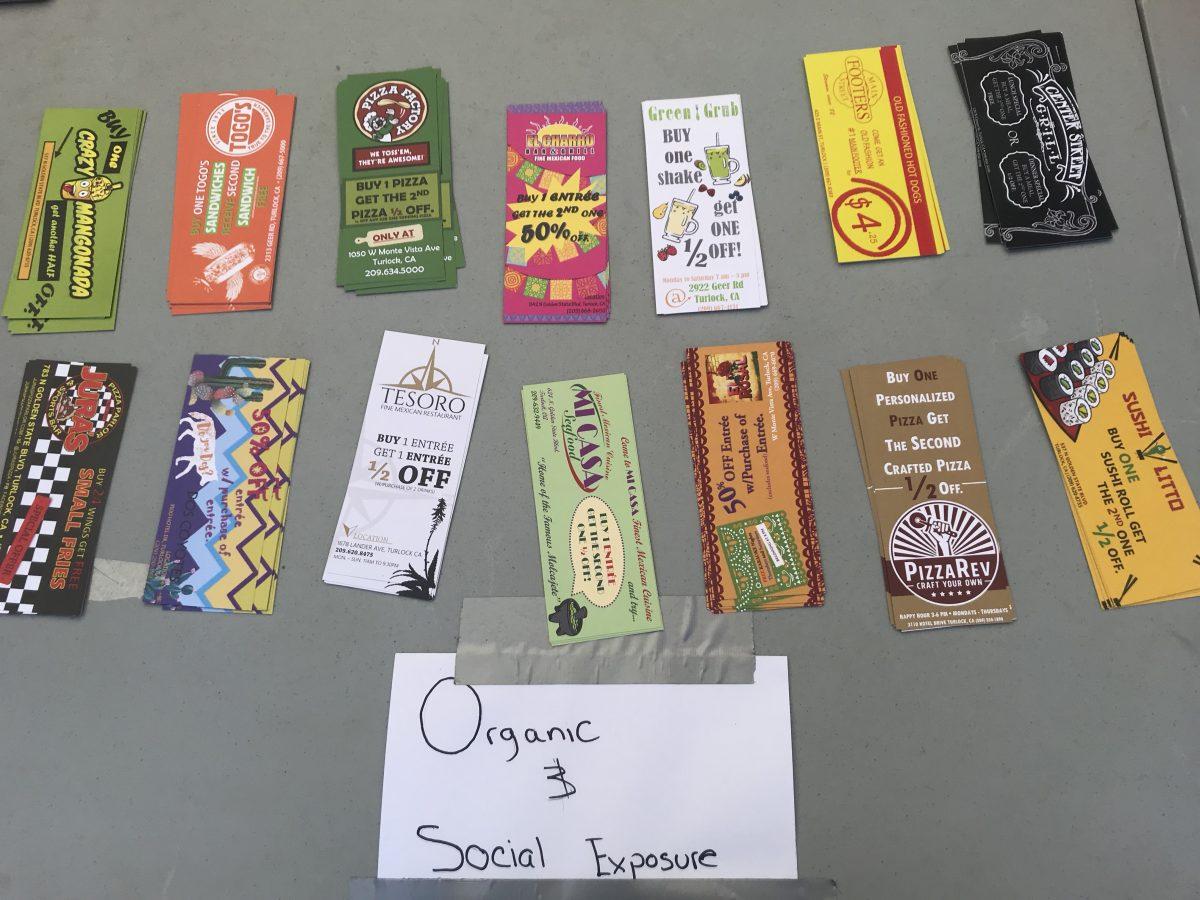 Coupons provided by Organic Social Exposure ready to give away to students. (Signal Photo/Abrianna Munoz)