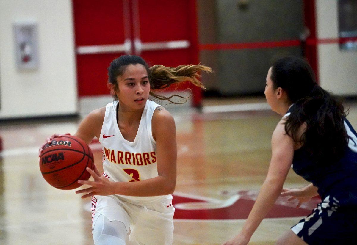 Guard Angelica Baylon (senior, Communication Studies) dribbling the basketball while attempting to create an pass. (Signal Photo/ Randel Montenegro)