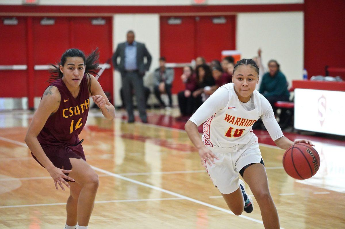 Guard Lauren Toler (sophomore, Child Development) dribbling the basketball. (Signal Photo/ Randel Montenegro)