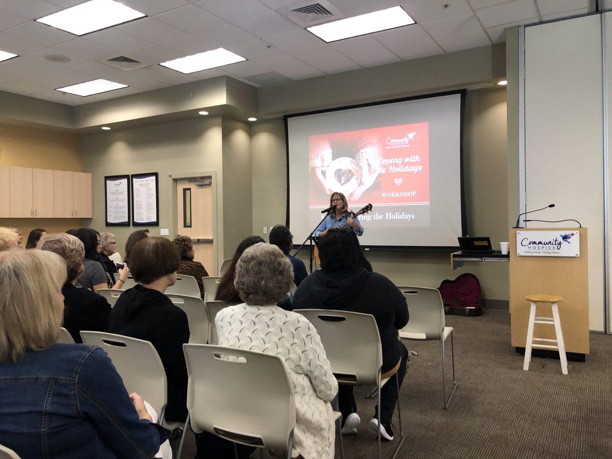 Grief Support Professional Sandy Gunnarson singing her self-wrote song at the event. (Signal photo/ Aliyah Stoeckl)