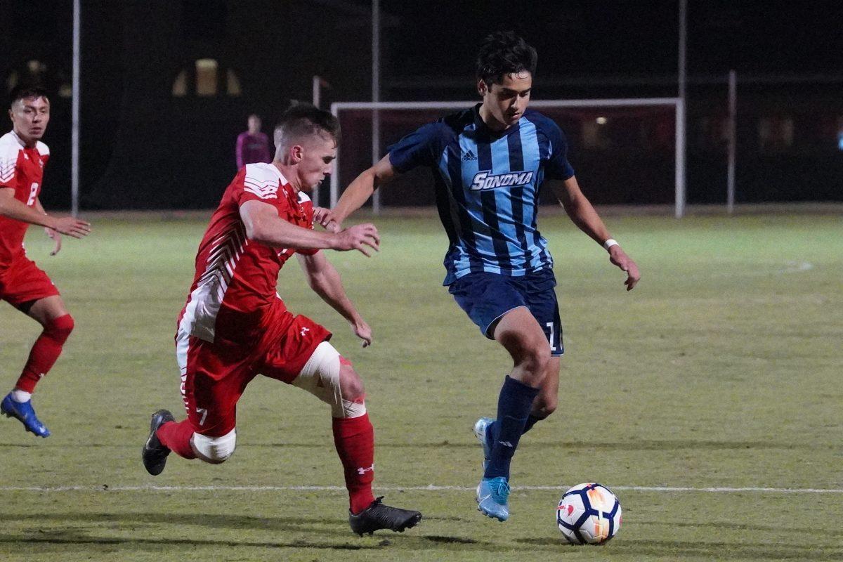 Men's Soccer team attempting to defend the ball from Sonoma State. (Signal Photo/ Randel Montenegro)