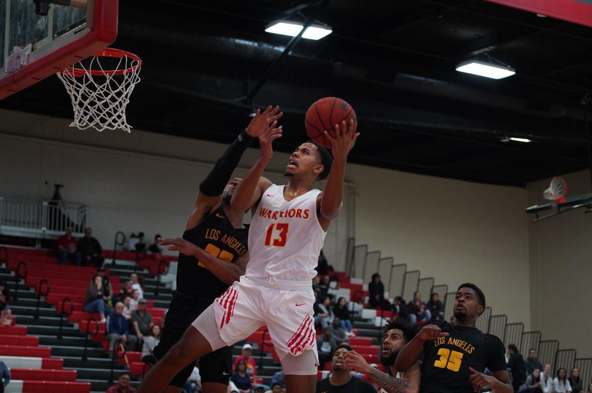 Guard Darius Scott (senior, Criminal Justice) attempting to score an layup. (Signal Photo/ Randel Montenegro)