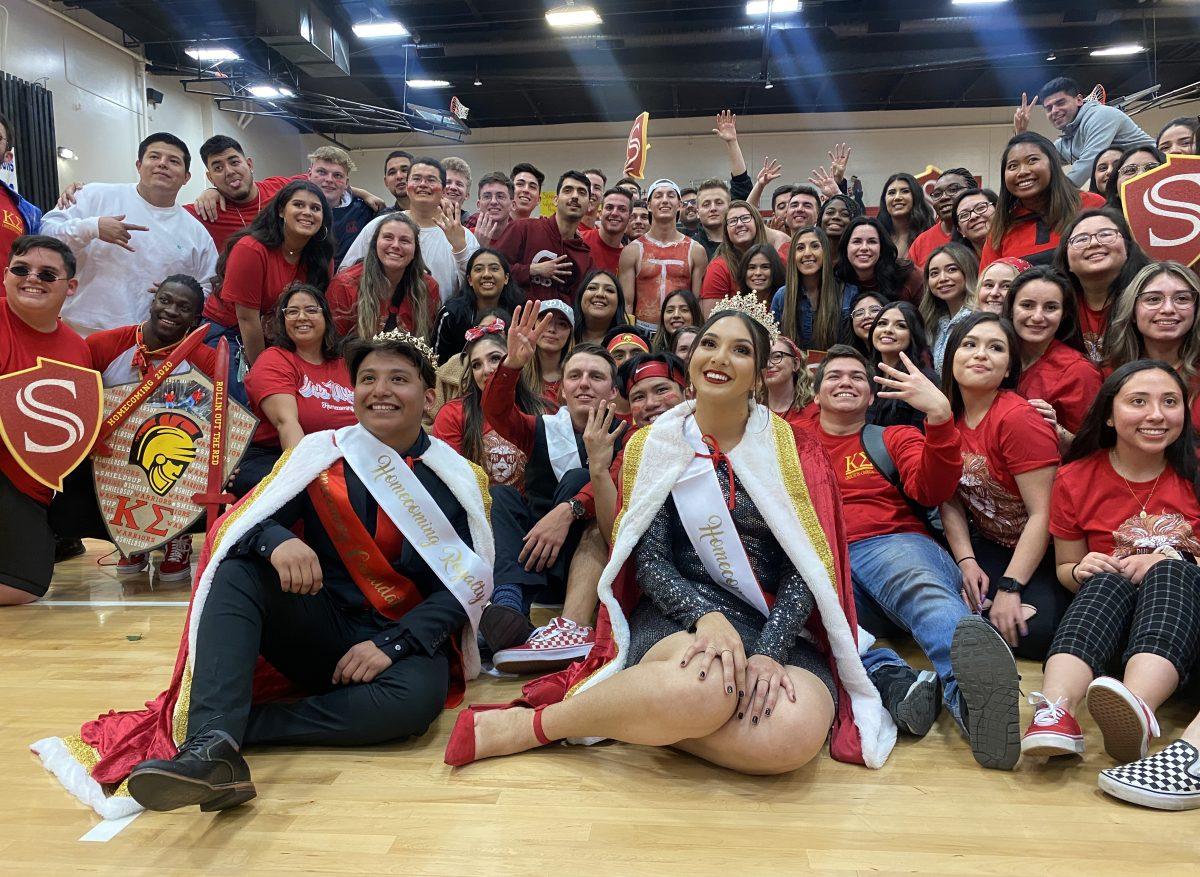 Jonathan "Johnny" Perez (senior, Criminal Justice) and Alyssa Torres (senior, Sociology) posing for a group picture with fellow Stan State Warriors. (Signal Photo/ Randel Montenegro)