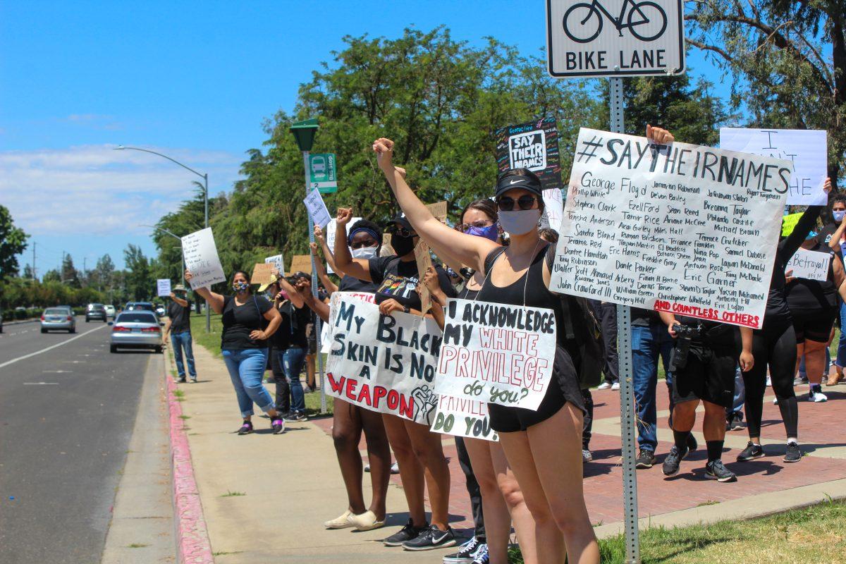Community members participated at a recent Black Lives Matter protest. The protest took place at the corner of Geer Road and Monte Vista Avenue, in front of the Stan State campus. (Photo courtesy of the Turlock Journal)