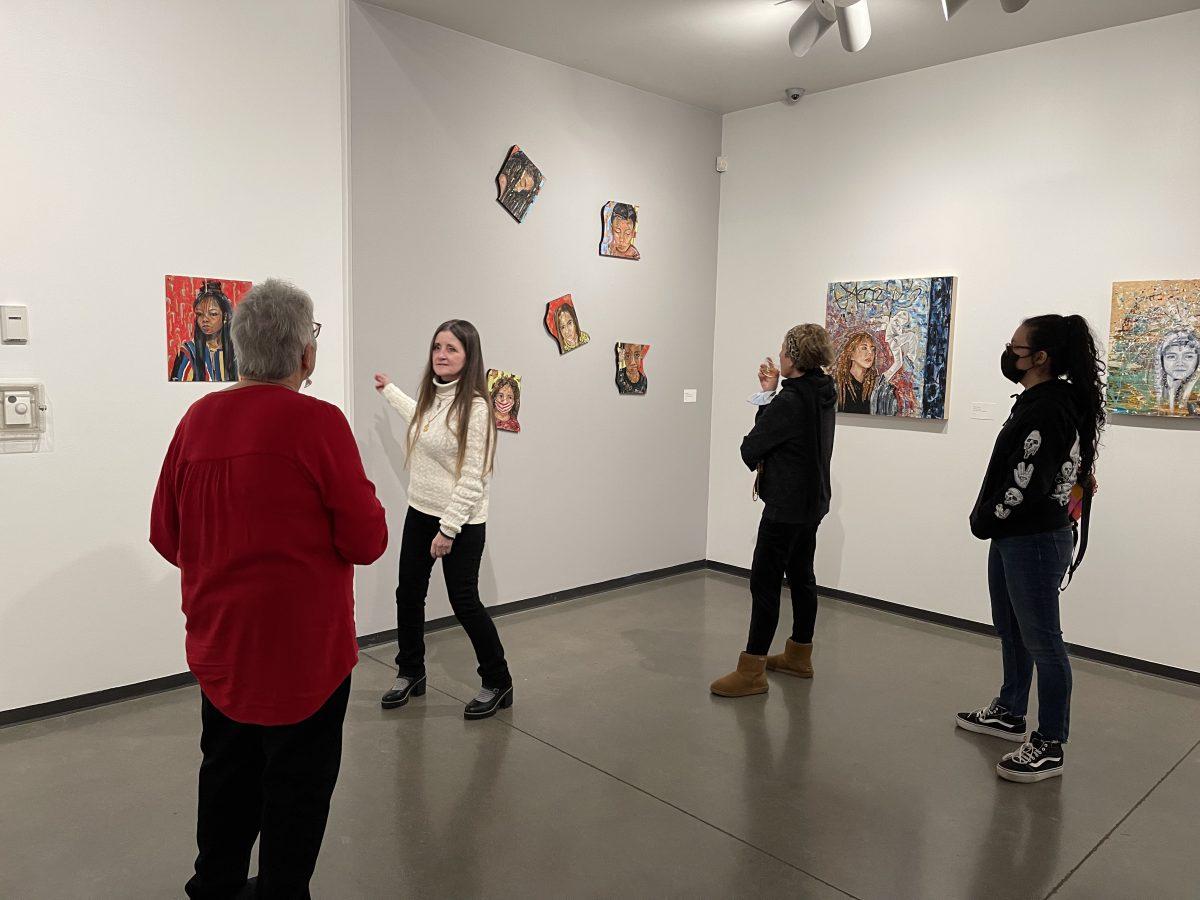 Deborah Barr discusses her painting, "Tell me Again," which is oil on Bristol board. (Signal Photo/Vipanpreet Kaur)