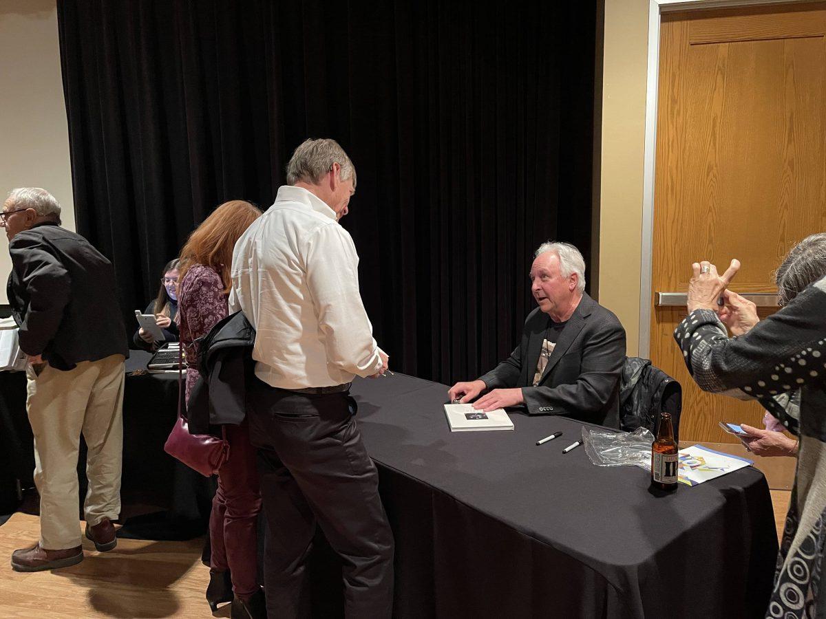 Jackson Nichols signing a copy of his new book for fans. (Signal Photo/Vipanpreet Kaur)