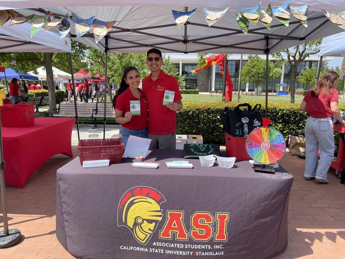 Cynella Aghasi with her team member operating a booth in the quad during Earth Week celebrations.&#160;