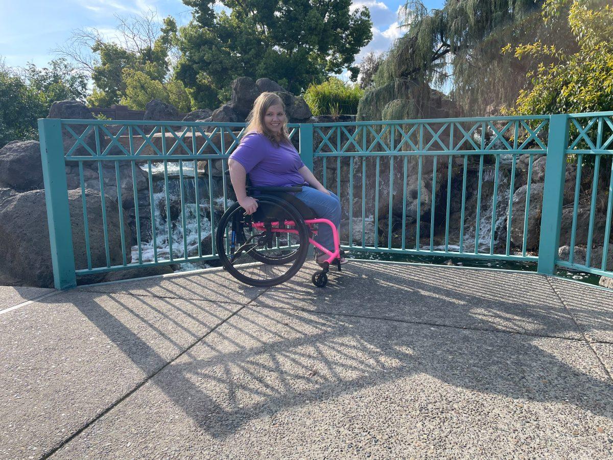 Caitlin in her pink wheelchair showing that she has a disability (Photo contributed by Caitlin Cox)
