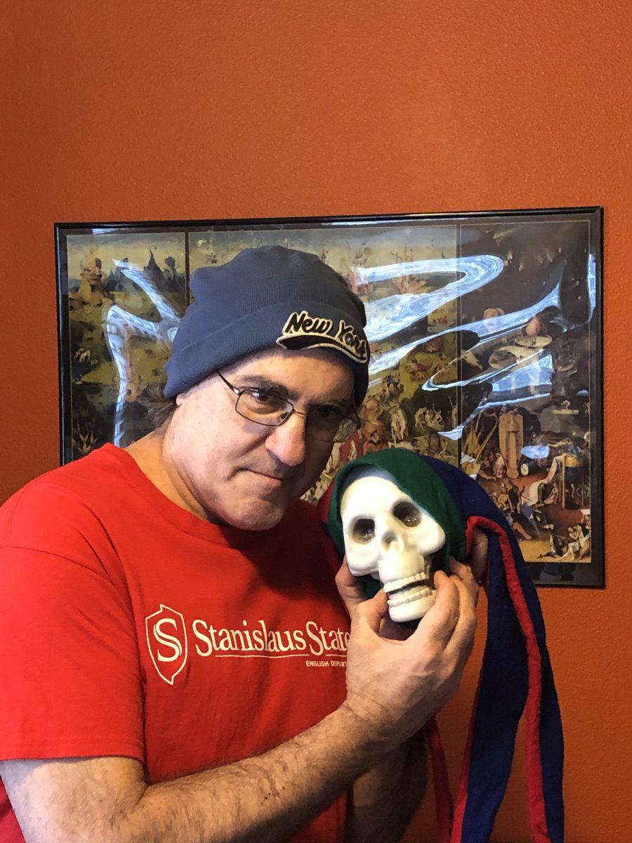 Professor Perrello posing with a skull in front of Hieronymus Boschs The Garden of Earthly Delights (Photo contributed by Anthony Perrello)