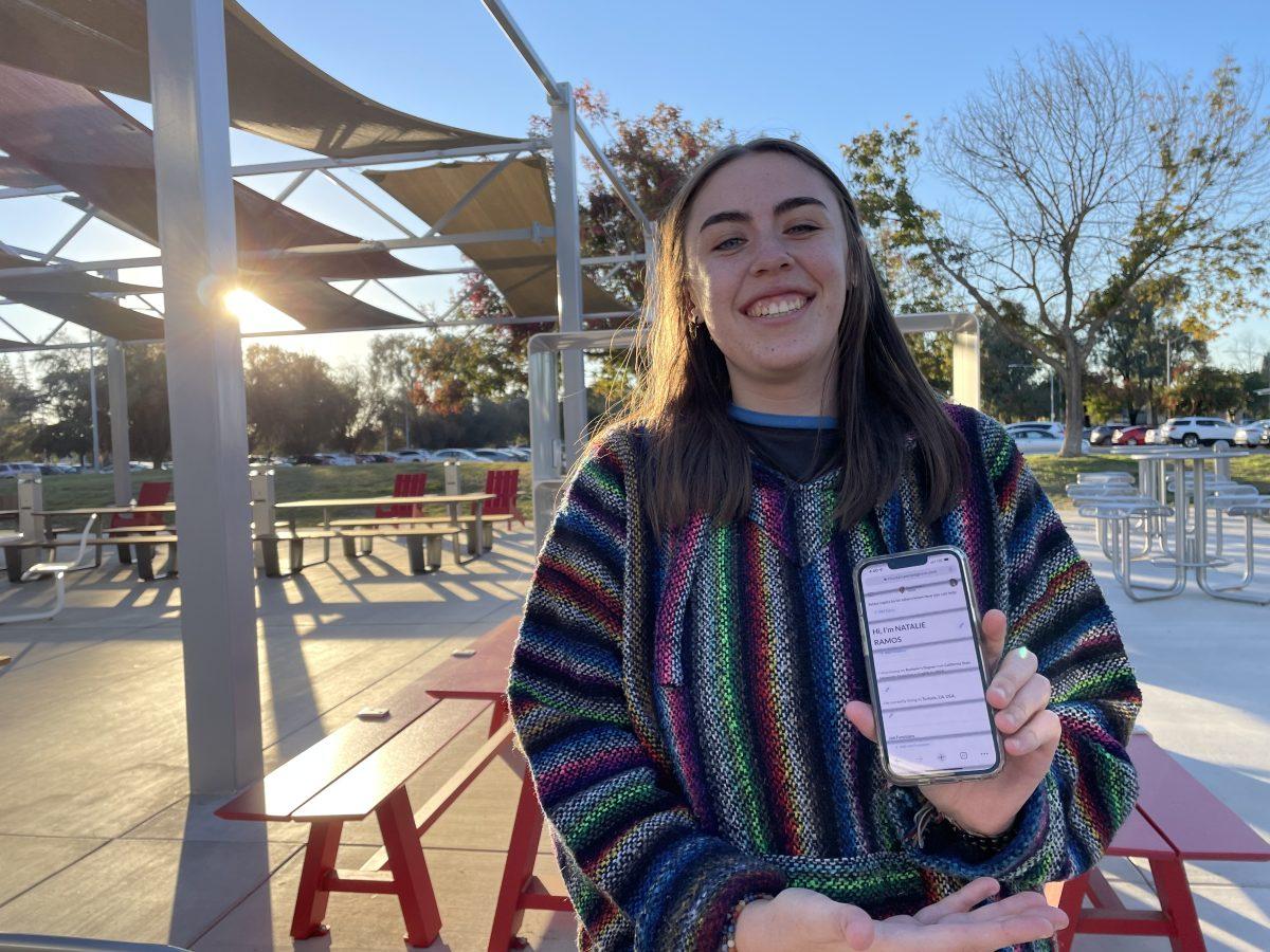 Stan State student, Natalie Ramos, holds up the mobile version of PeopleGrove on her phone. (photo curtsey Ariana Espinoza) 