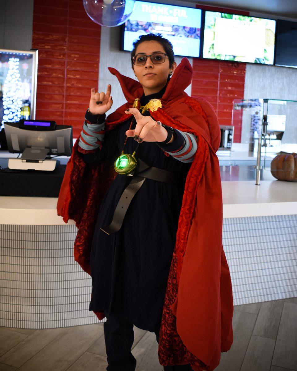 Lu Aguiniga dressed up as Dr. Strange by the Red Wave in the Student Center. Photo by Katelyn Hawthorne.