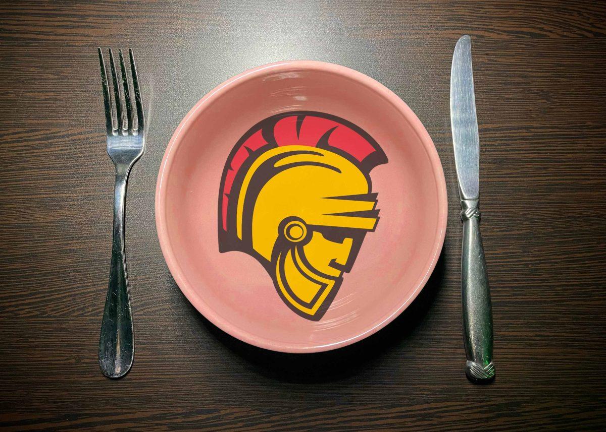 Image of a bowl with the Stan State Warrior head logo in between a fork and knife. Photo by Katelyn Hawthorne