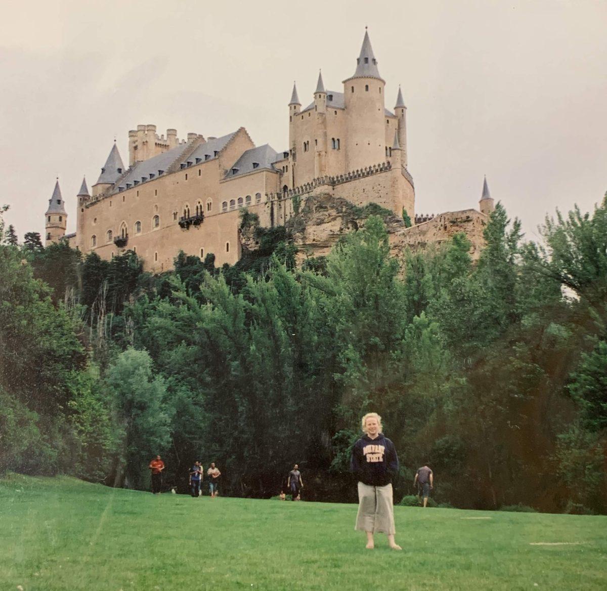 Brittany Fentress posing in front of a castle during her time studying abroad in Segovia, Spain around 2005. (Photo Credit: Brittany Fentress)