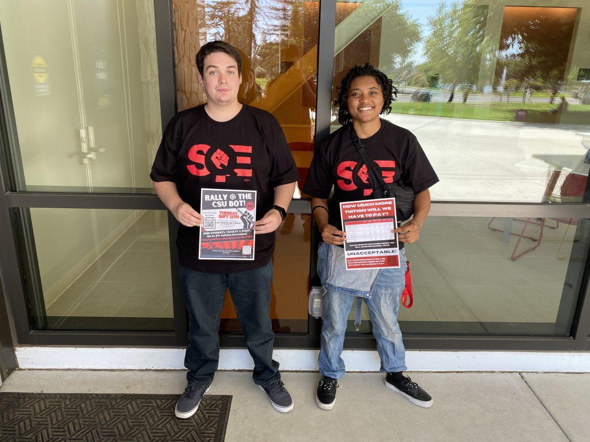 Raymond Gonzales & Taylor Hawkins, a pair of SQE interns, posing with their flyers. (Signal Photo/Adan Cortes)
