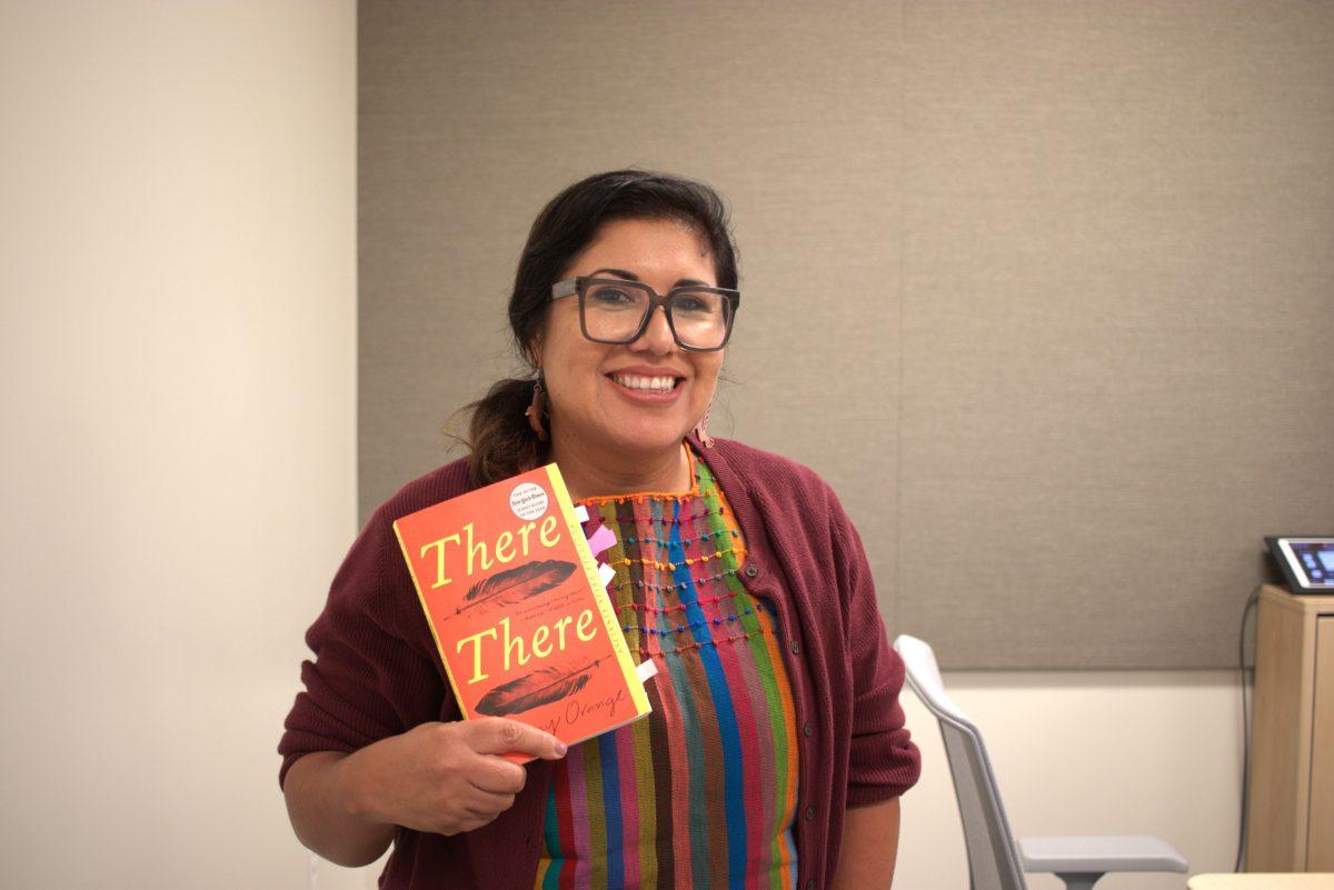 Director of the WCCC, Carolina Alfaro, holding the book There There by Tommy Orange. (Signal Photo/Marc Briones) 